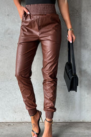 Brown leatherette gathered waist joggers with cinched cuffs and pockets.