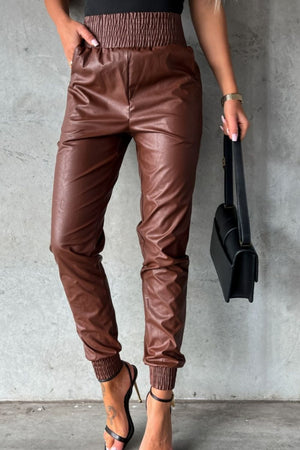 Brown leatherette gathered waist joggers with cinched cuffs and pockets.