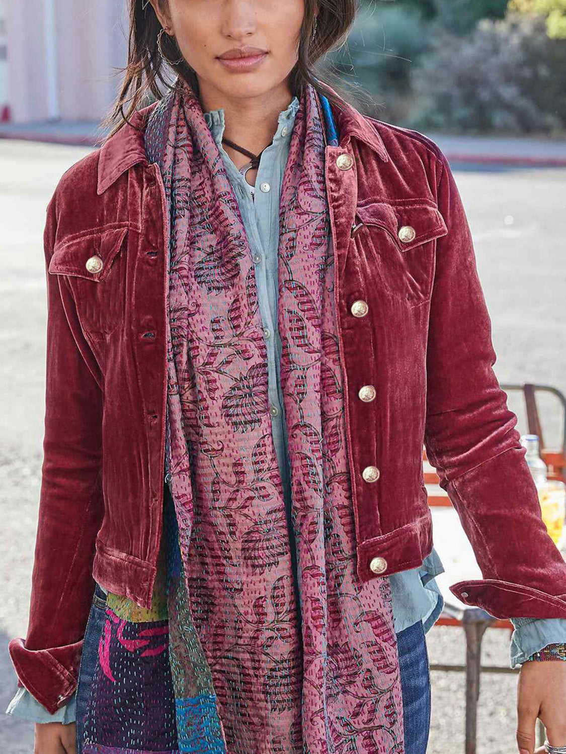 Burgundy velvet western jacket with silver buttons and a patterned scarf.