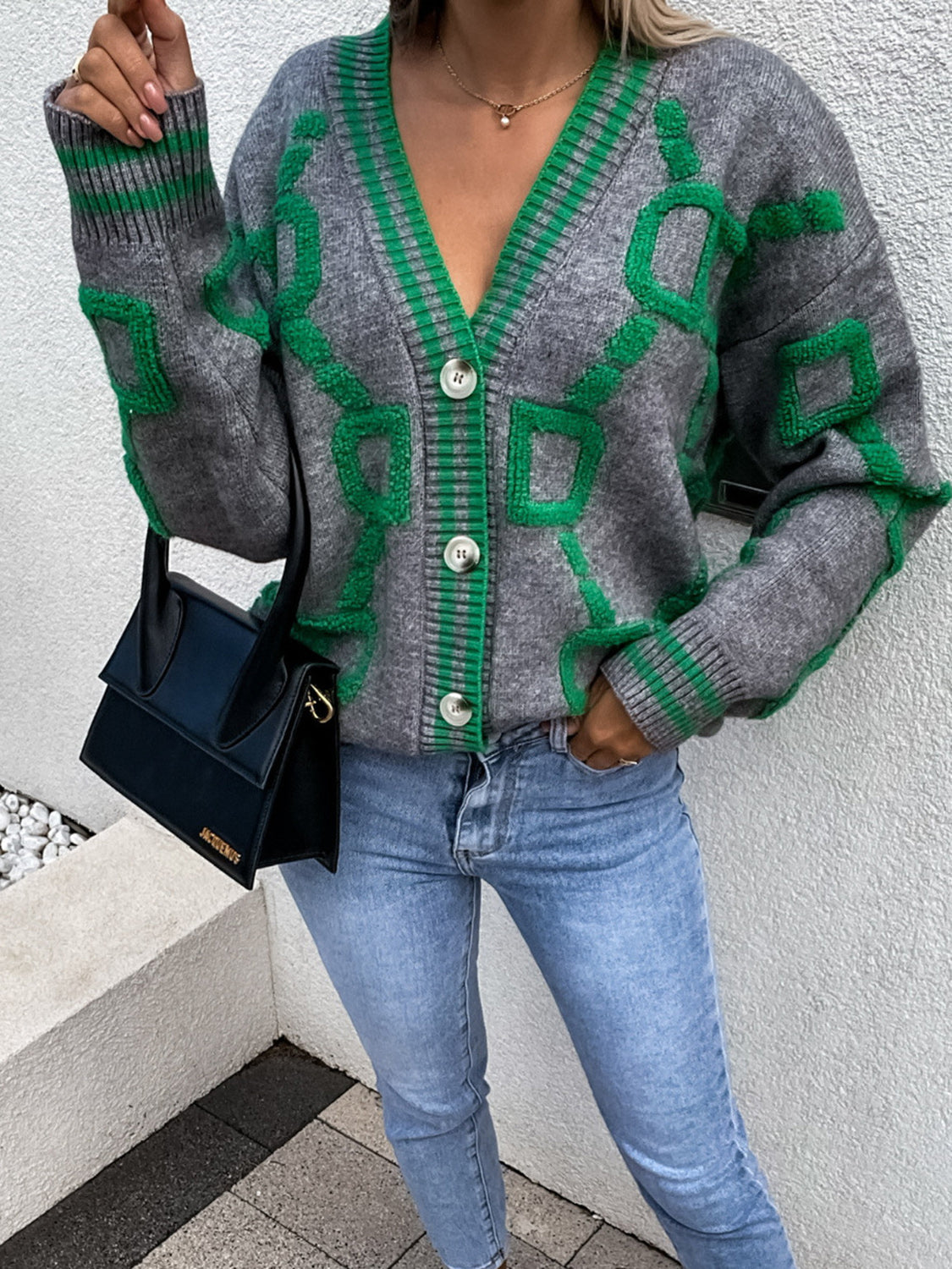 Grey acrylic cardigan with green geometric chain pattern, V-neck, button front, and ribbed cuffs.