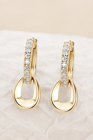 Gold pavé and teardrop sterling silver hoop earrings with cubic zirconia accents.