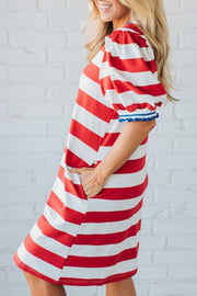 Red and white striped cotton mini dress with puff sleeves and blue trim.