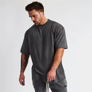 Oversized dark gray graphic tee with a washed-out look and crew neck.