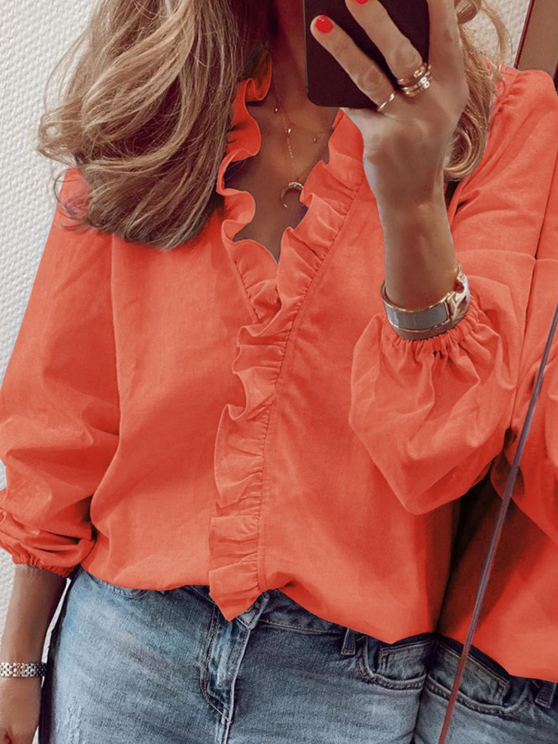 Pumpkin blouse with cascading ruffle front and balloon sleeves.