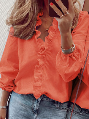Pumpkin blouse with cascading ruffle front and balloon sleeves.
