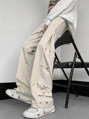 Men's beige snap button loose fit sweatpants with adjustable drawstring waist.