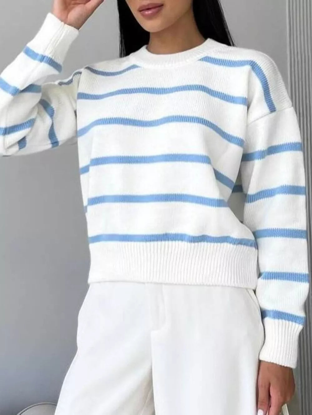 Classic striped knit sweater with round neck in white and light blue.