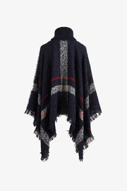Navy plaid turtleneck cape with fringe detail and textured acrylic knit.