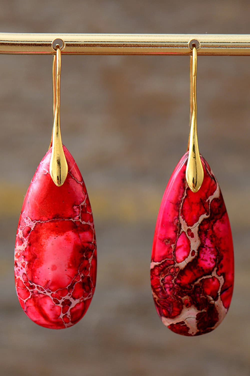 Ocean Jasper dangle earrings in red with gold accents and a unique marbled pattern.