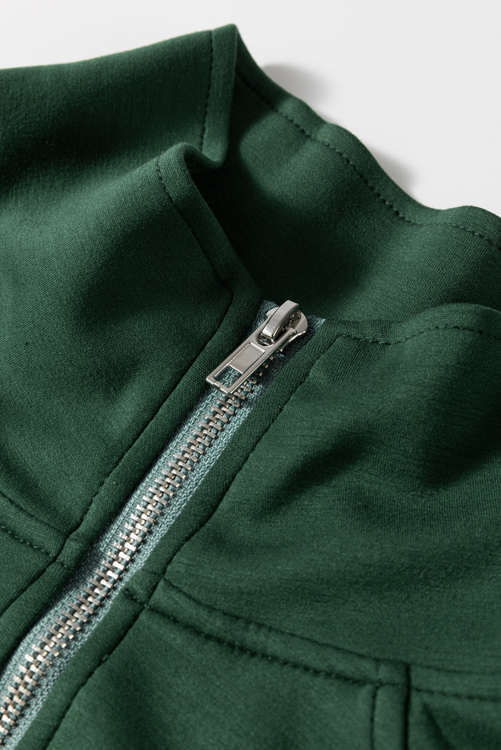 Dark green romper with funnel neck and silver zipper detail