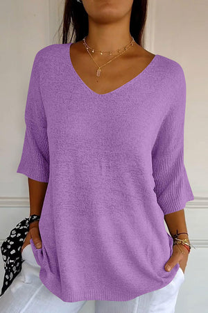 Lavender v-neck knit sweater with flared sleeves and a textured knit.