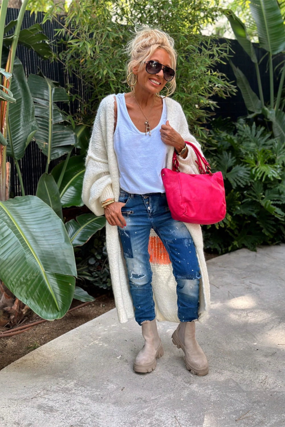 White maxi knit cardigan with open front and long sleeves, styled with jeans and a tank top.