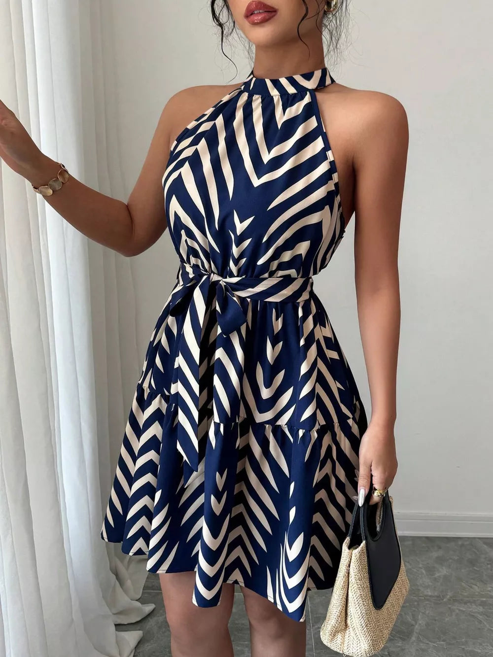 Blue and cream chevron print halter neck tie-waist ruffle dress.