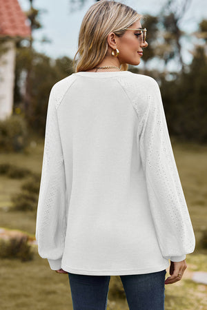 White waffle knit raglan top with eyelet detail on sleeves.