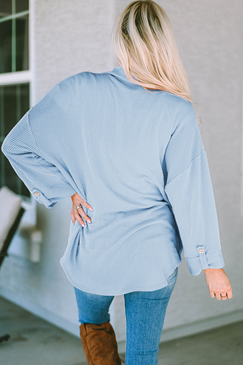 Light blue textured stripe oversized overshirt with button cuff details.