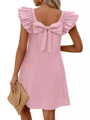 Pink a-line dress with ruffled cap sleeves and a large back bow detail.