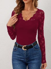 Burgundy ribbed top with scalloped lace neckline and sleeves.