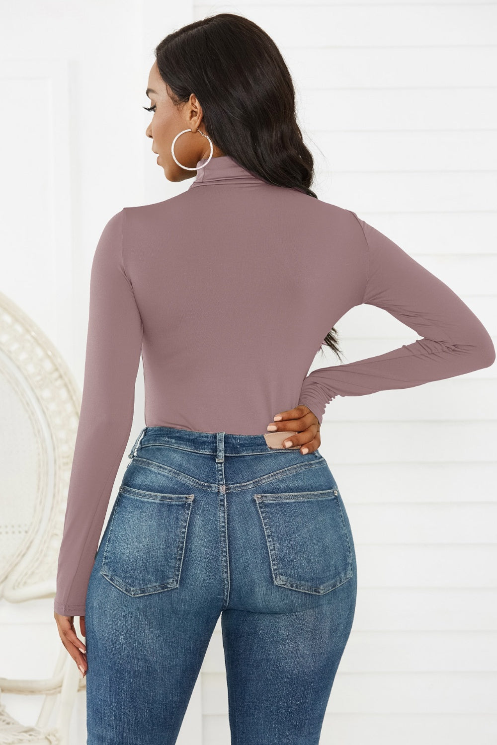 Long sleeve turtleneck bodysuit in dusty pink, styled with jeans