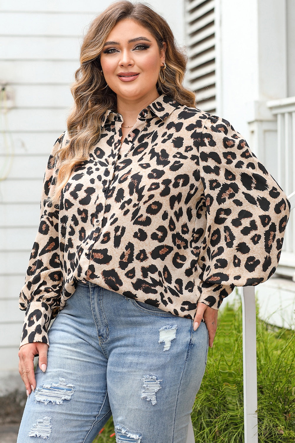 Leopard print blouse with blouson sleeves and collared neckline.
