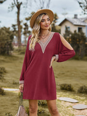 Wine cold shoulder mini dress with lace trim neckline and cuffs.