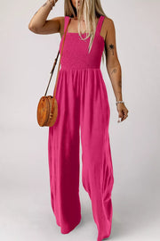 Smocked bodice wide leg romper in deep rose with square neckline and adjustable straps.