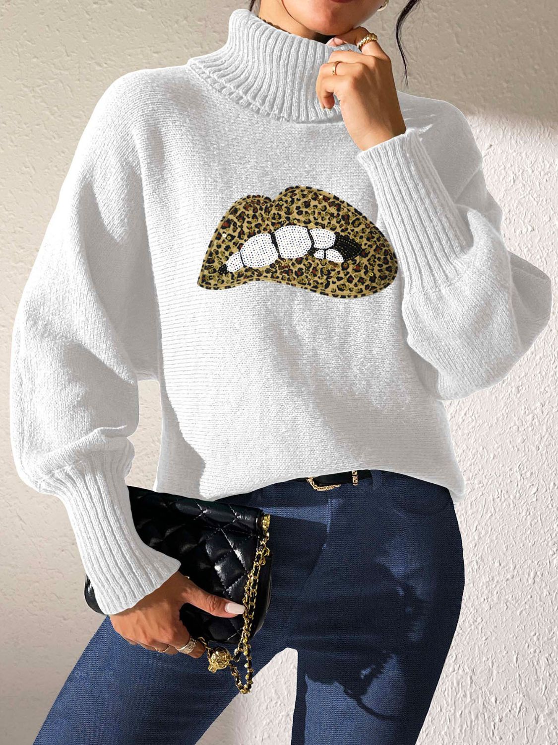 White turtleneck sweater with sequin leopard lip graphic and balloon sleeves.
