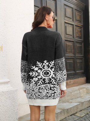 Black knit mini dress with snowflake intarsia pattern, crew neck, long sleeves, and ribbed trim.