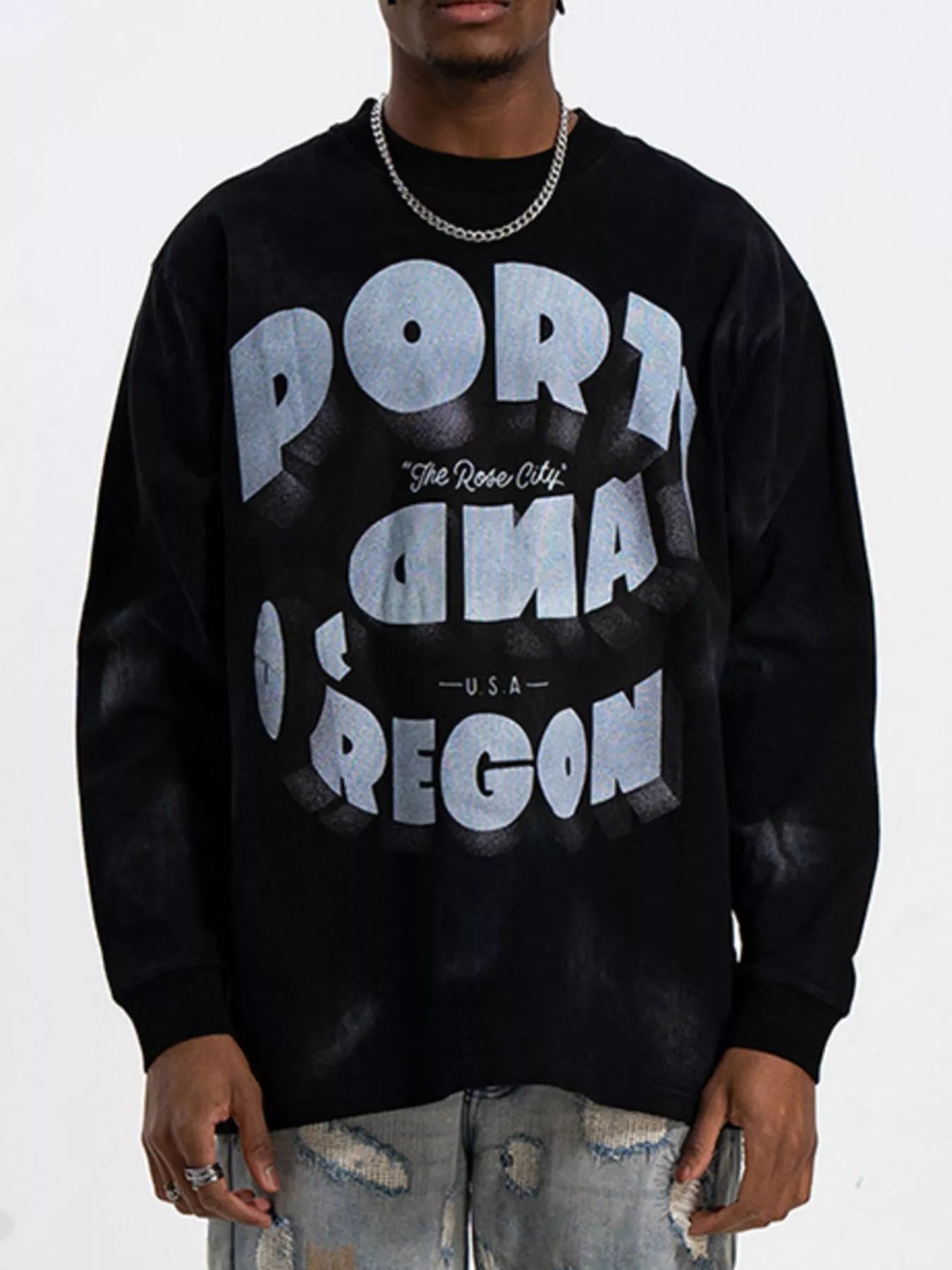 Black oversized long-sleeve t-shirt with bold "PORTLAND OREGON" graphic print.