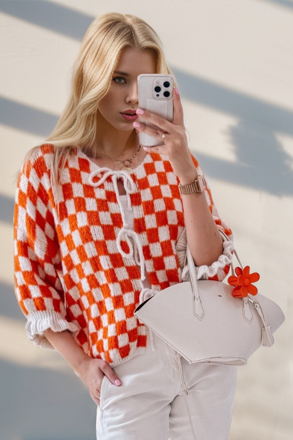 Orange and white checkered knit cardigan with tie-front and ruffle sleeves