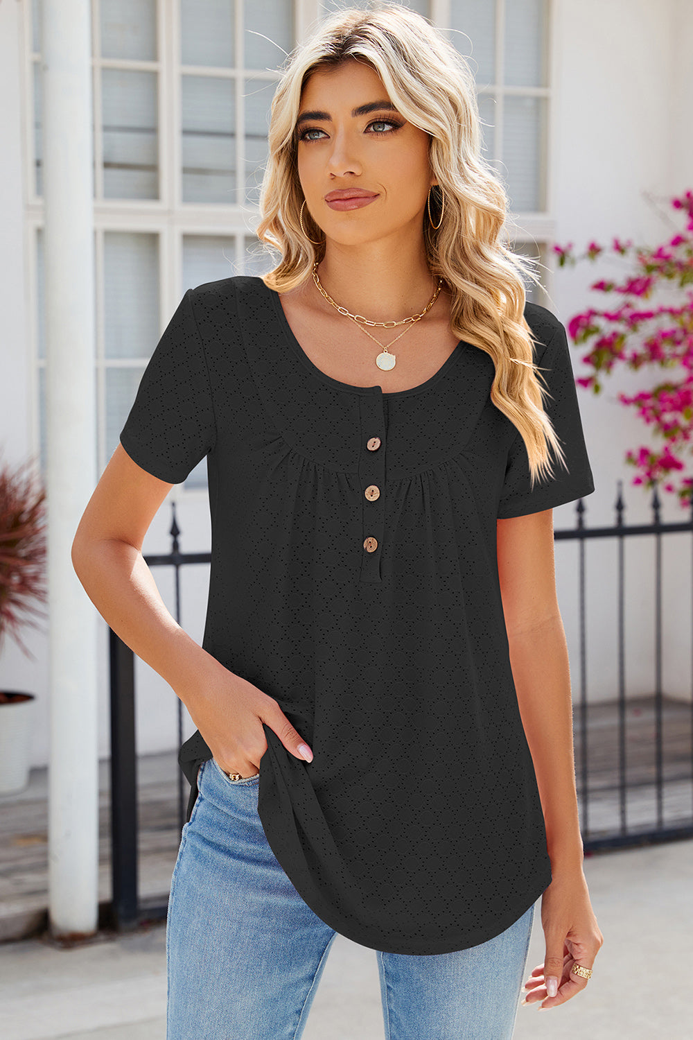 Black eyelet yoke gathered henley shirt with button detail and short sleeves.