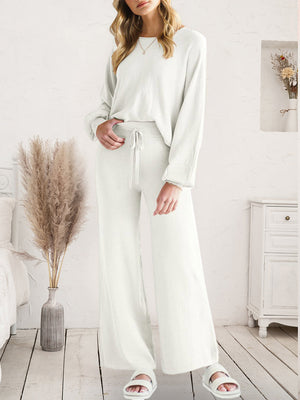 Ivory wide-leg knit loungewear set with drawstring waist and long sleeves.