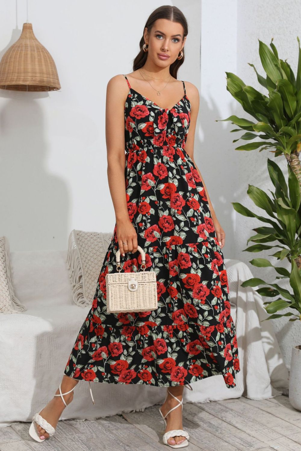 Floral print maxi dress with spaghetti straps and tiered skirt.