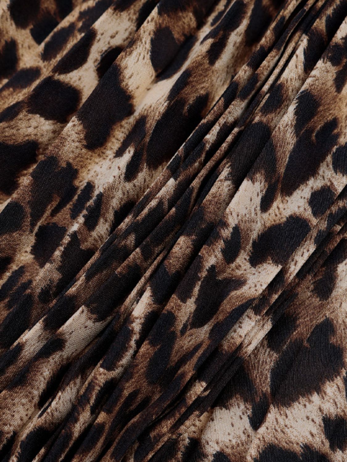 Leopard print maxi skirt with knife pleats and a draped detail.