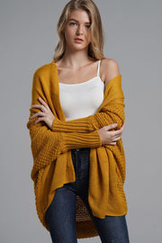Mustard knit batwing cardigan with drape front and textured sleeves.