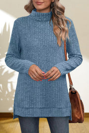 Sky blue ribbed knit turtleneck tunic top with side slits and long sleeves.