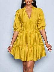 Yellow tiered mini dress with notched V-neck and puff sleeves.