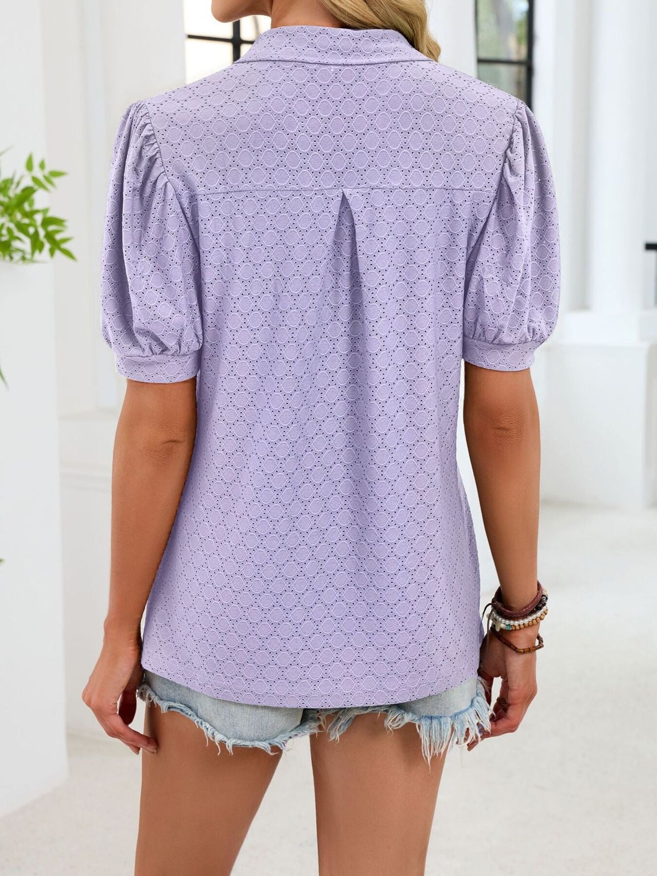 Purple eyelet puff sleeve collar top with a textured pattern.