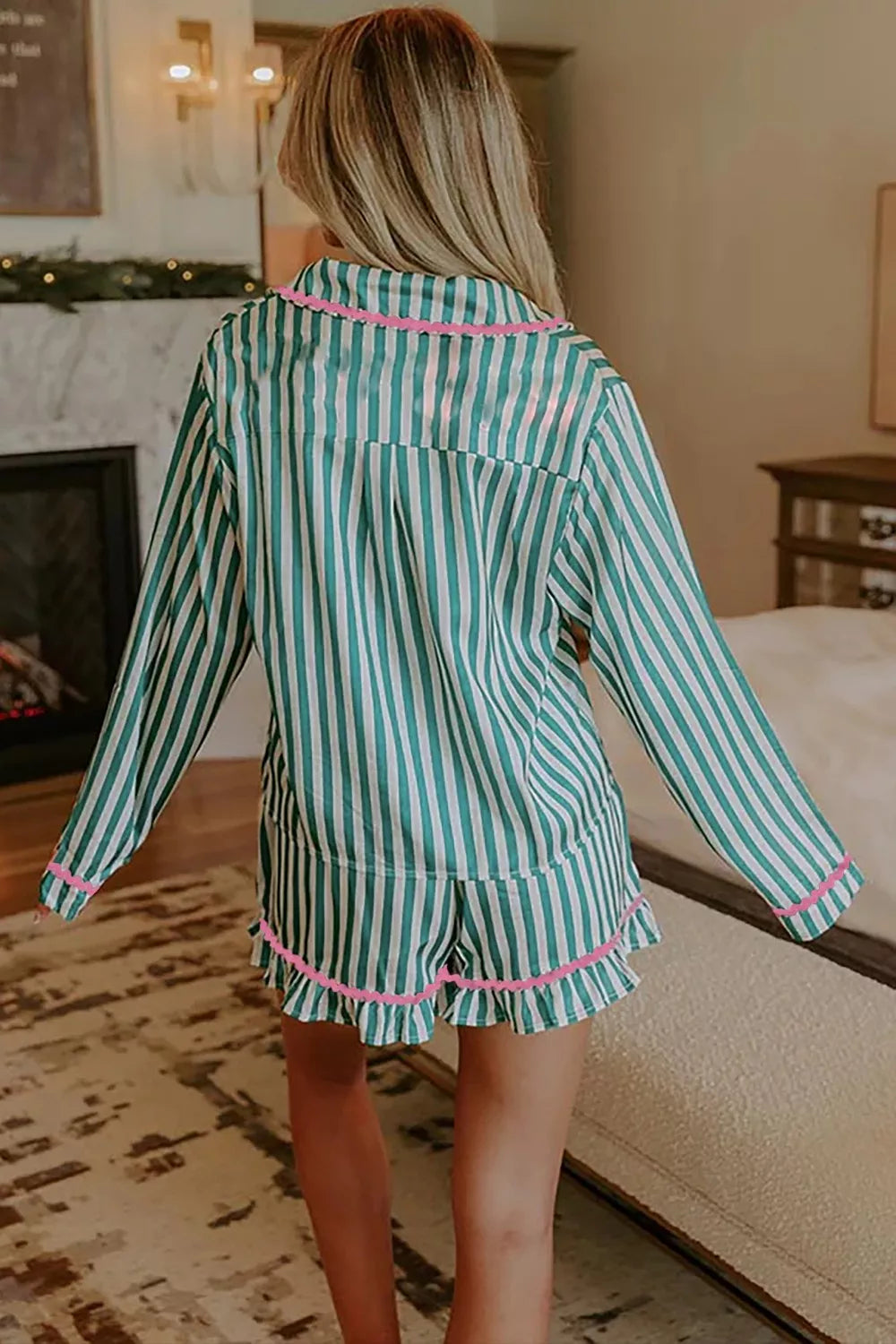 Green and white striped pajama set with pink trim and ruffled shorts.
