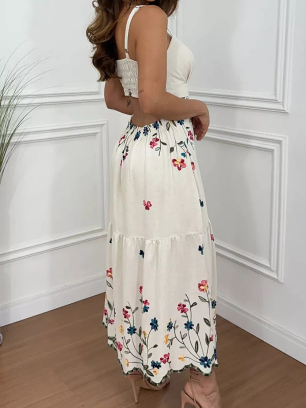 White midi dress with embroidered floral detail and cutout back.
