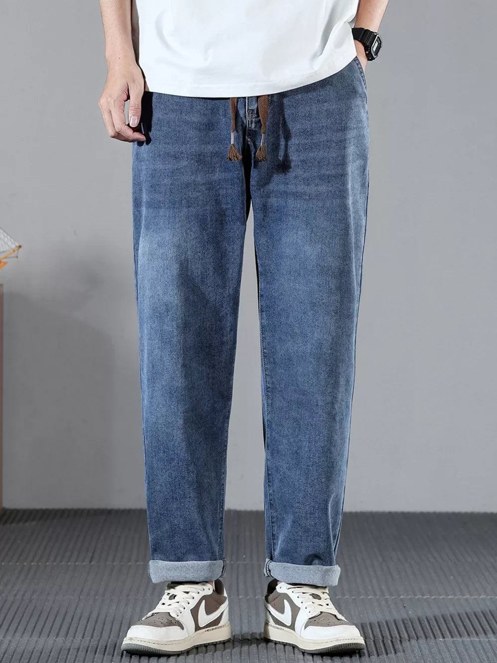 Men's blue cotton wide leg jeans with drawstring waist and cuffed hems