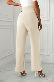 Beige wide-leg trousers with a sculpted waist, shown from the back.