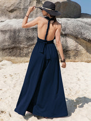 Dark blue halter neck wide leg jumpsuit with braided back detail and tie waist.
