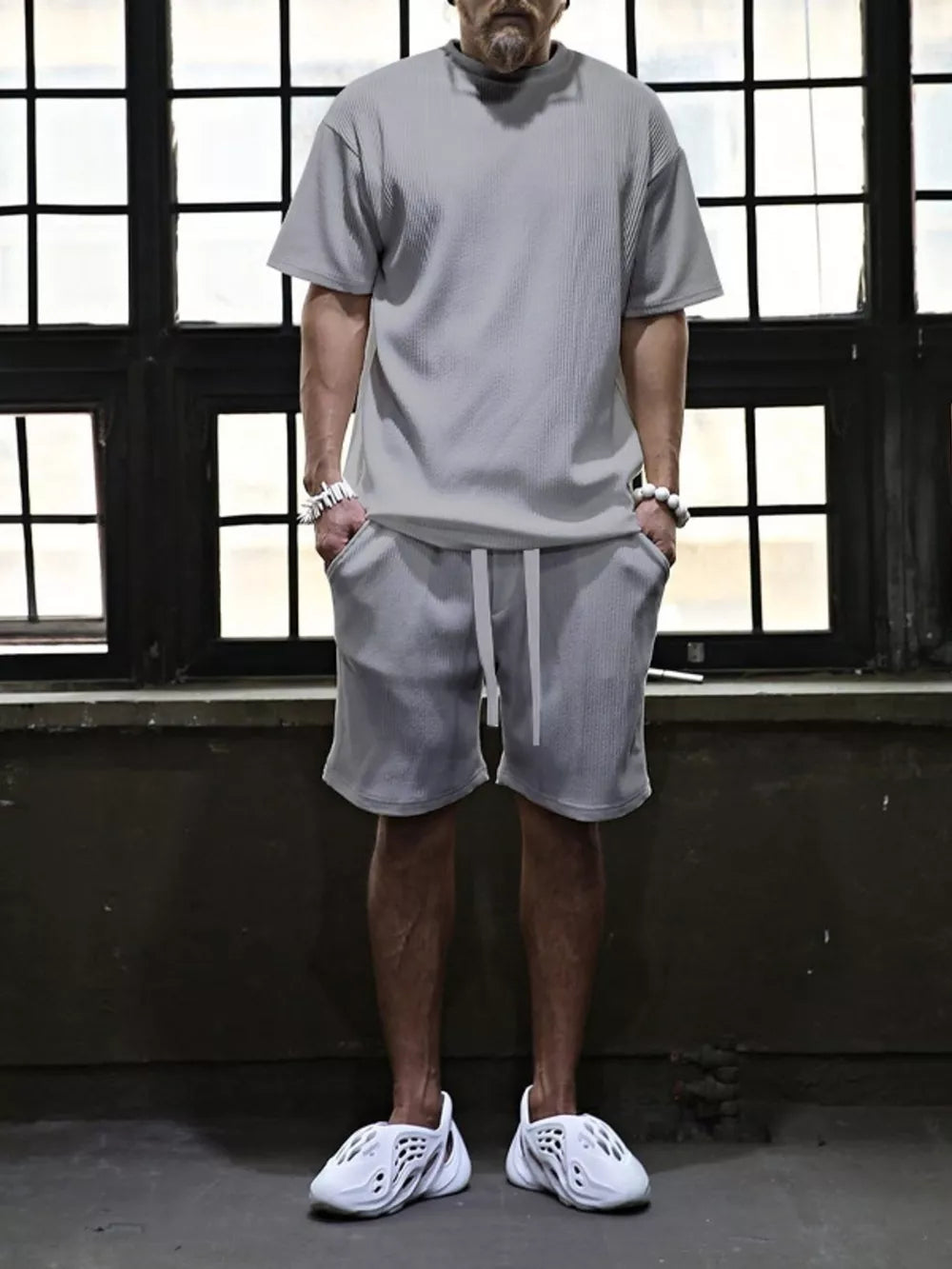 Men's grey ribbed t-shirt and drawstring shorts set with white accents