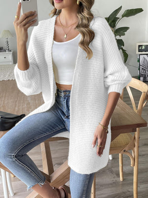 White ribbed knit dolman sleeve cardigan with a relaxed fit, styled with a tank top and jeans.