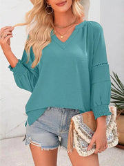 Teal long sleeve polyester blouse with smocked cuffs and V-neck.