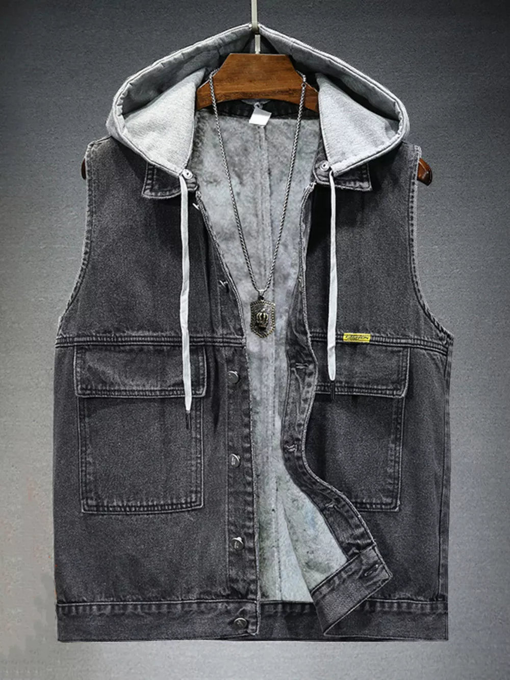 Black hooded denim vest with fleece lining and button-down front.