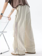 Cream cargo sweatpants with adjustable waist and mesh side detail.