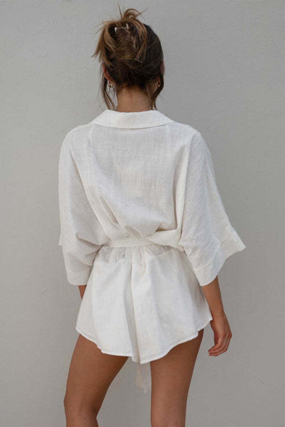 White linen kimono sleeve romper with tie waist and collar detail