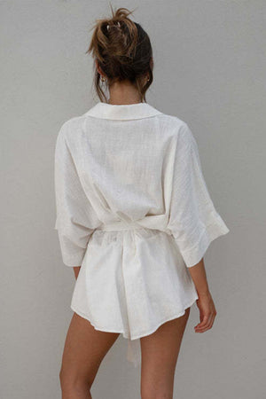 White linen kimono sleeve romper with tie waist and collar detail
