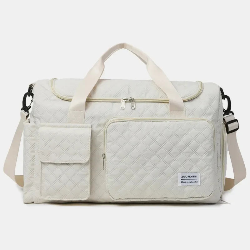 White quilted duffel bag with olive accents, featuring multiple pockets and dual handles.